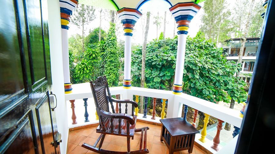 Image of a balcony with wooden chair and table at WOW Bison Woods.
